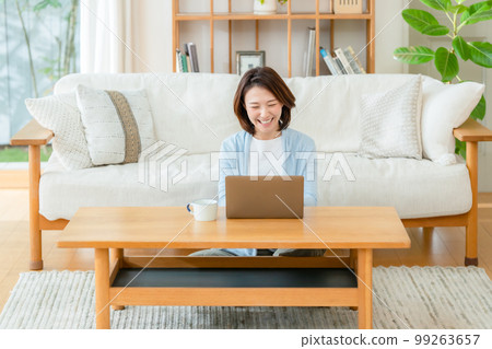 Female living room computer smile Female living room computer smile 99263657