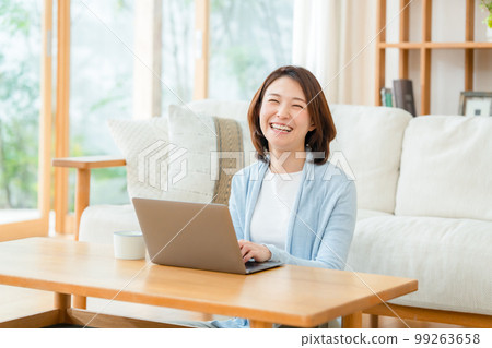 Female living room computer smile Female living room computer smile 99263658
