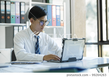 Businessman is analyzing online marketing on laptop computer Businessman is analyzing online marketing on laptop computer 99264263