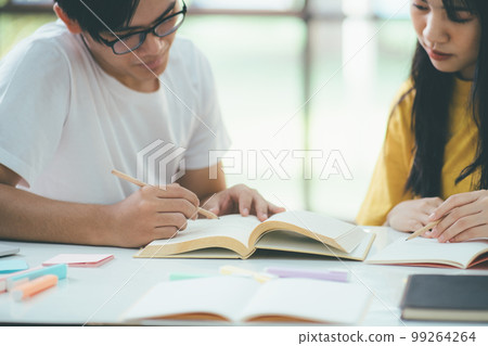 Close up an asian students are reading books and study, Tutoring together. 99264264