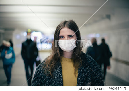 group of residents in protective masks walking in the underpass 99265645