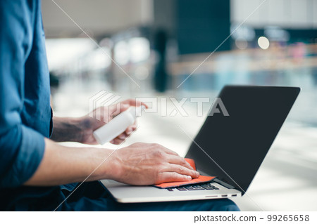 close up. man wiping dust from the laptop keyboard . close up. man wiping dust from the laptop keyboard . 99265658