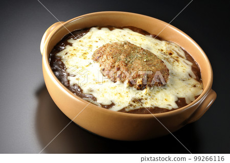 A grilled curry with plenty of cheese and hamburger on a black background 99266116