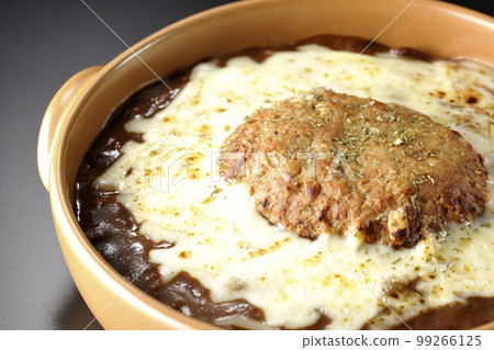 A grilled curry with plenty of cheese and hamburger on a black background 99266125