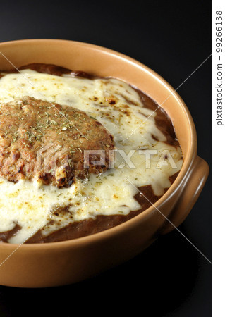 A grilled curry with plenty of cheese and hamburger on a black background 99266138