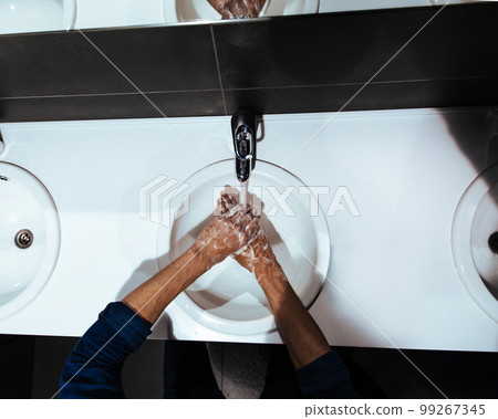 close up. man carefully washes his hands with soap 99267345