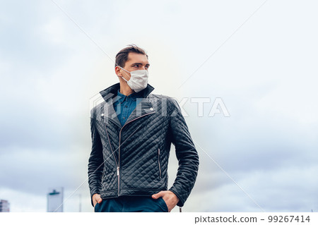 man in a protective mask against the background of a modern city 99267414