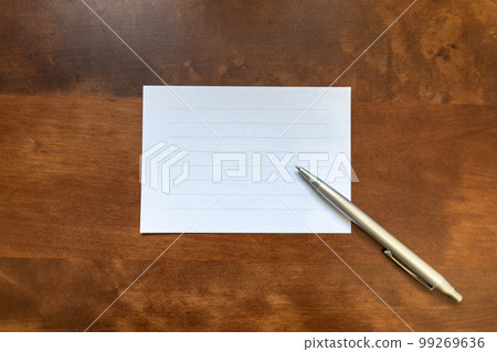 Letter paper and ballpoint pen on a wooden table Image of conveying feelings 99269636