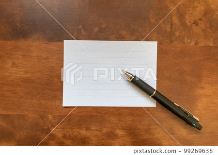 Letter paper and ballpoint pen on a wooden table Image of conveying feelings 99269638