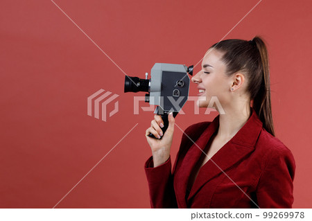 Woman profile with old vitage home movie camera studio shot isolated. Woman profile with old vitage home movie camera studio shot isolated. 99269978