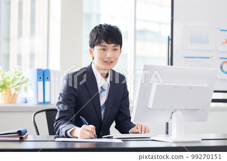 Business desk work man looking at computer Business desk work man looking at computer 99270151