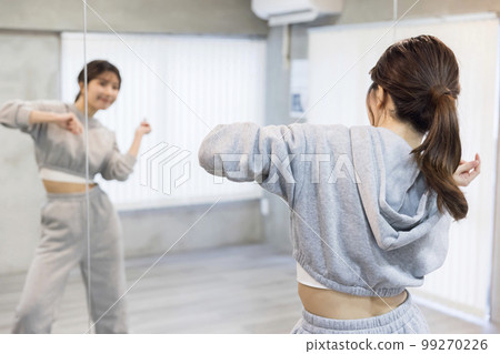 Young woman dancing while looking at the mirror in the dance studio Dance hip hop image 99270226
