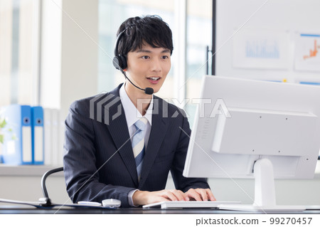 Male operator working in a business call center Male operator working in a business call center 99270457