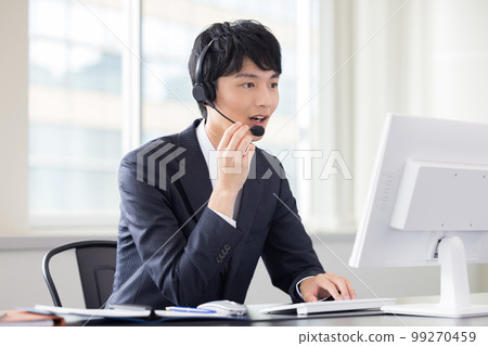 Male operator working in a business call center Male operator working in a business call center 99270459