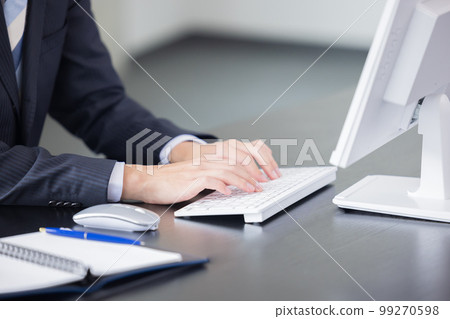 Business man's hand working on a personal computer 99270598