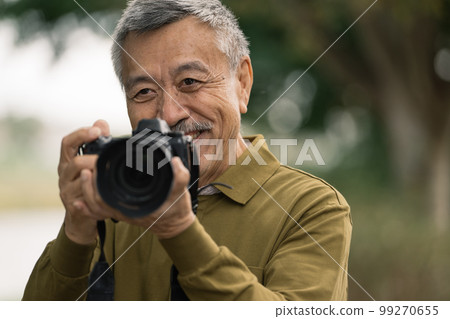 Senior men taking pictures 99270655