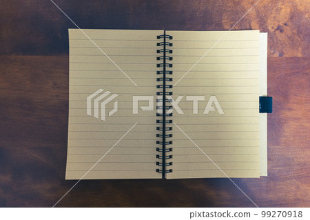 Close-up of a notebook opened on a wooden table Retro style Close-up of a notebook opened on a wooden table Retro style 99270918