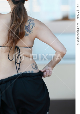 Back of a woman dancing Tahitian dance 99271038