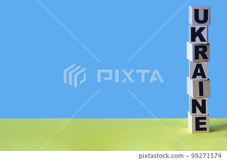Ukraine, word in wooden alphabet letters isolated on blue and yellow background Ukraine, word in wooden alphabet letters isolated on blue and yellow background 99271574