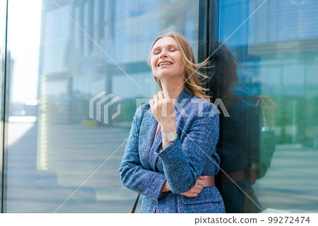 Confident successful smiling business woman entrepreneur in suit standing 99272474