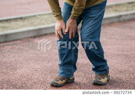 Senior man's feet walking along the river 99272734