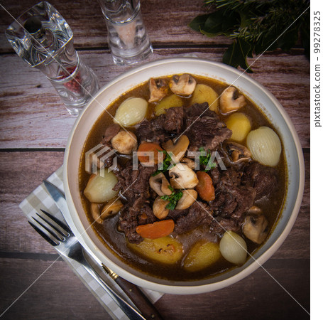 Beef bourguignon recipe, beef stew with wine sauce and vegetables 99278325