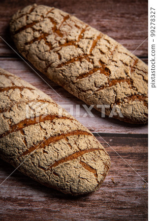 Rye bread on brown background 99278327