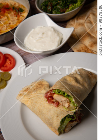 Lebanese recipe of chich taouk, garlic cream, toum, in a Lebanese bread, tabbouleh and chickpea 99278386