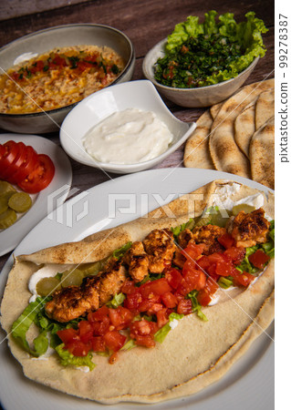 Lebanese recipe of chich taouk, garlic cream, toum, in a Lebanese bread, tabbouleh and chickpea 99278387