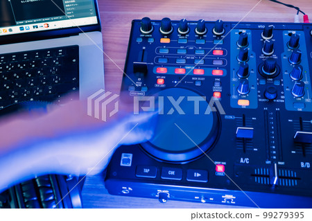 Man enjoying mixing in his room 99279395