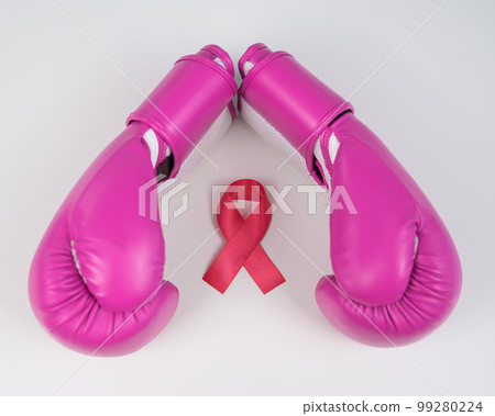 Pink boxing gloves and a pink silk ribbon on a white background. Breast cancer concept.  99280224