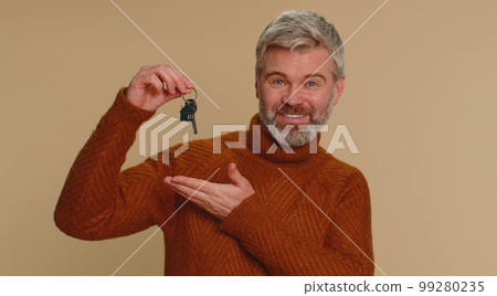 Middle-aged man real estate agent showing keys of new home house apartment, buying renting property 99280235