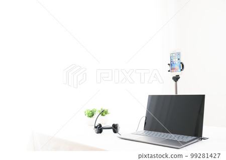 Indoor white table, laptop, smartphone, headphones, foliage plants Indoor white table, laptop, smartphone, headphones, foliage plants 99281427
