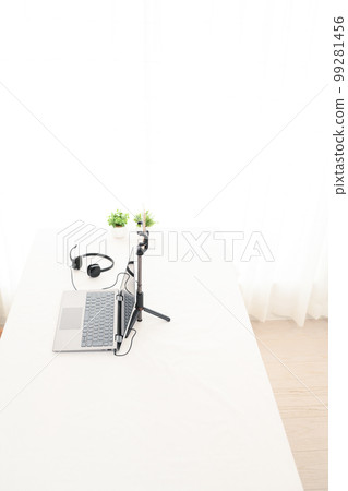 Indoor white table, laptop, smartphone, headphones, foliage plants Indoor white table, laptop, smartphone, headphones, foliage plants 99281456