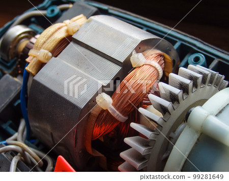 Repair of the brush electric motor. The device of the collector brush assembly of the electric motor. Rotor, collector, brushes close up. 99281649