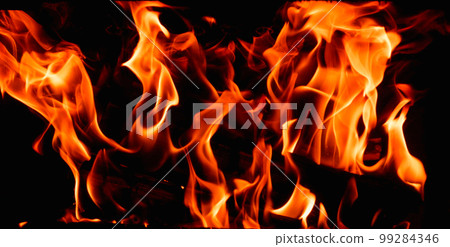 Hot, orange flames of burning wood in the fireplace. Fire dance on black background. Hot, orange flames of burning wood in the fireplace. Fire dance on black background. 99284346