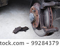 Car repair. Replacing the brake pads of disc brakes. Brake disc close-up. 99284379