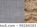 Top view photo of Crumpled craft paper and Beige mat of dry wicker fiber as texture, background. 99284383
