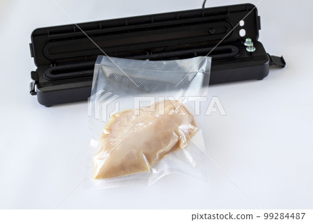 Fillet of chicken breast sealed by vacuum cooking machine sous vide, on a white background 99284487