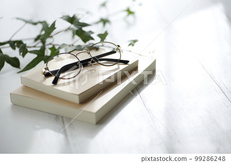 books and glasses on the desk 99286248