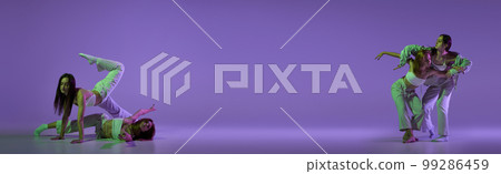 Music in moves. Young expressive contemp dance dancers dancing in neon light. Concept of dance, youth, hobby, dynamics, movement, action, ad. Banner with copy space 99286459