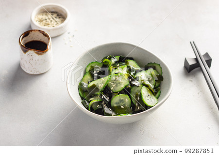 Traditional Japanese Sunomono salad with wakame seaweed, cucumbers and sesame seeds. 99287851