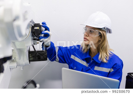 female technician engineer using laptop checking automation robotics at industrial modern factory. female technician engineer using laptop checking automation robotics at industrial modern factory. 99288670