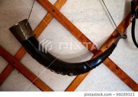 Black Wine Horn hanging on the wall, close-up photo. 99289321