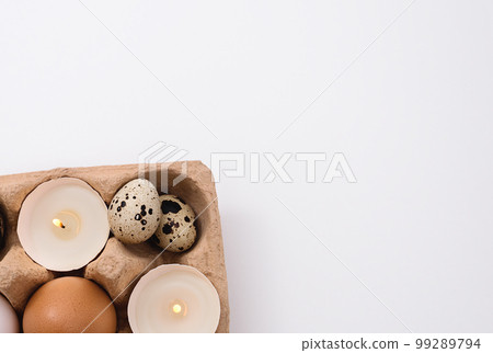 Quail Eggs and candle in tray 99289794