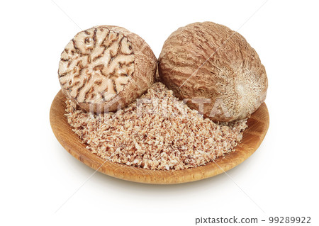 Whole and grated nutmeg in wooden bowl isolated on white background with full depth of field. 99289922