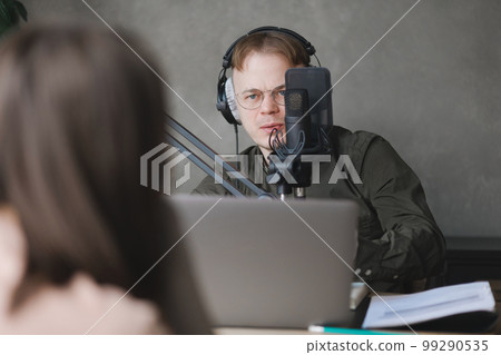 man and woman in studio record podcast, create audio content, advertising message man and woman in studio record podcast, create audio content, advertising message 99290535