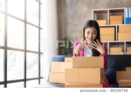 online business ideas Asian businesswoman holding parcel boxes preparing to deliver to customers with joy 99290746
