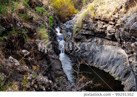 Mountain stream Meshushim. Nahal Meshushim. Rocks in the form of hexagonal basalt columns. Mountain stream Meshushim. Nahal Meshushim. Rocks in the form of hexagonal basalt columns. 99291302