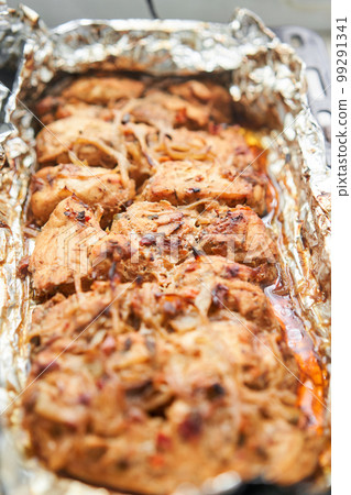 Baked chicken breast. Baked in foil with onions and seasonings. Home cooking. Healthy food, cooked without oil and salt. Baked chicken breast. Baked in foil with onions and seasonings. Home cooking. Healthy food, cooked without oil and salt. 99291341